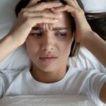 woman has alcohol withdrawal symptoms of headache and fatigue